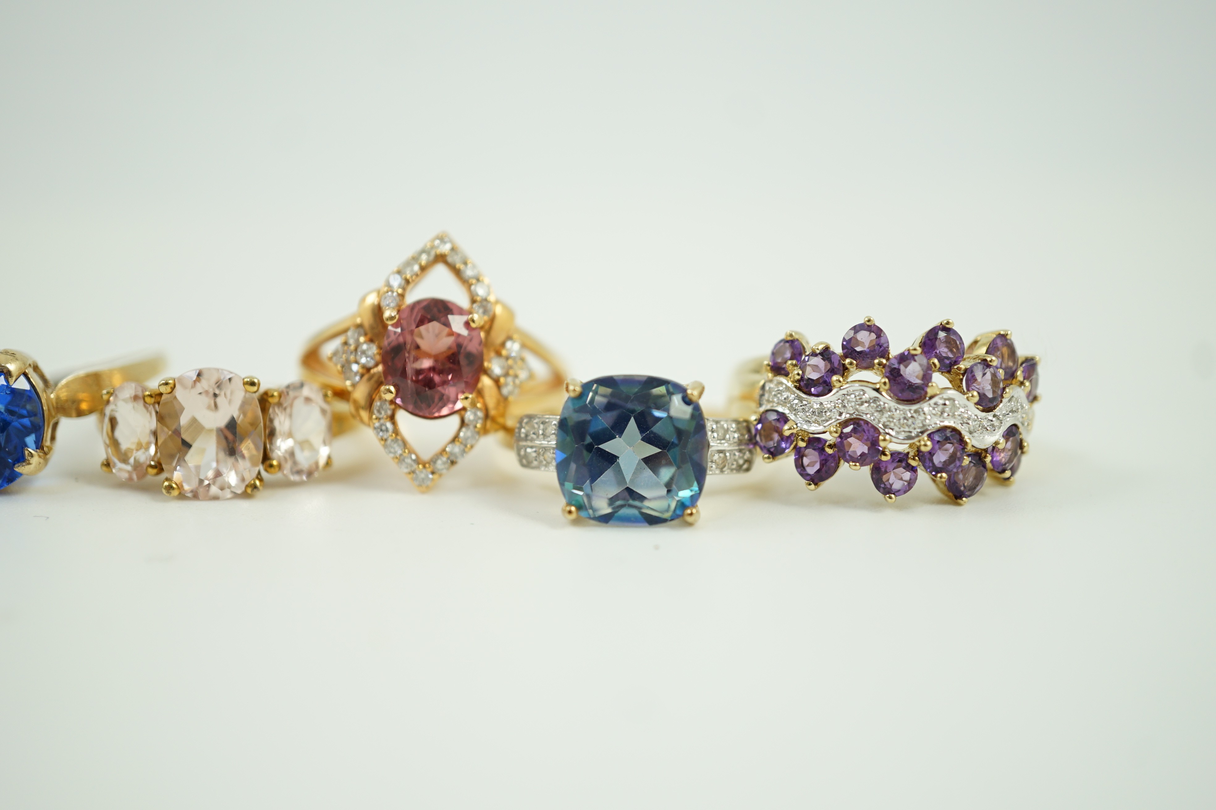 Four assorted modern 9ct gold and gem set rings and a similar 9k gem set ring, gross weight 16 grams.